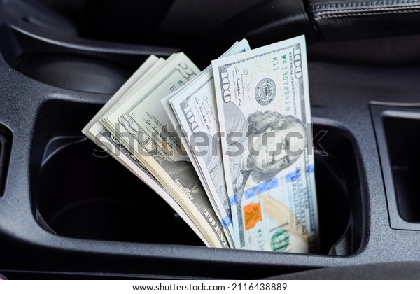A wad of dollars inside the car. A wad of dollars\
inside the car.