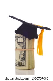 A Wad Of Hundred Dollar Bills Wrapped Around Themself With A Mortarboard Ontop Depicting The High Cost Of Education Or The College Admission Bribery Scandal. 