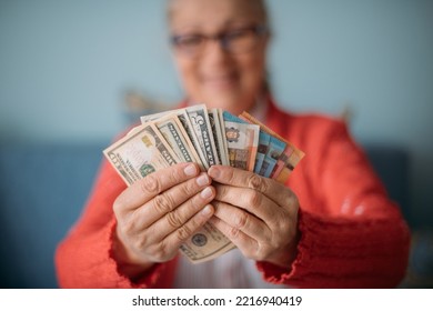 A wad of money, a fan of bills in his hands. Close-up. A lot of money in women's hands - Shutterstock ID 2216940419