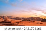 Wadi Rum, Jordan. A beautiful vibrant blue and orange sunset, Arabian desert, a dystopian martian landscape with unique rock formations and dunes. Backdrop for graphic resource or copy space no people