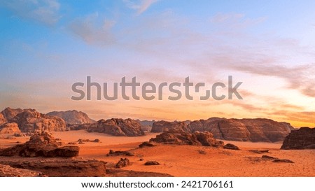 Wadi Rum, Jordan. A beautiful vibrant blue and orange sunset, Arabian desert, a dystopian martian landscape with unique rock formations and dunes. Backdrop for graphic resource or copy space no people