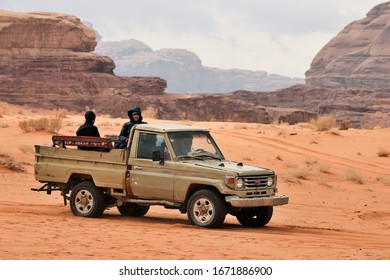 Wadi Rum Village, Jordan - February 19, 2020. Tourists sitting in pickup truck and enjoying a guided tour in Wadi Rum desert. - Shutterstock ID 1671886900