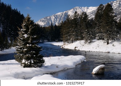 Wading Fishermen On Madison River In Winter With Snowy Rocky Mountain Madison Range Montana