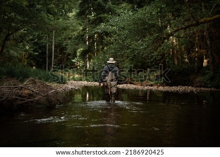 Wading through water while fly fishing 