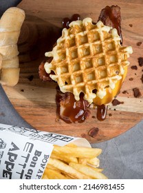 Waffle burger with cheese, bacon and some tequeños and fried potatoes 