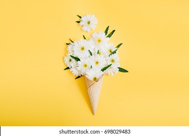 Waffle Cone With Chamomile Flower Bouquet On Yellow Background. Flat Lay, Top View Floral Background.