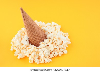 Waffle Cone With Salted Popcorn On Yellow Background. Creative Food Concept. Pop Art Design, Top View, Minimal Style