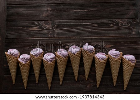 Waffle cones with marshmallows. View from above. Creative flat lay, copy space. Place for text.