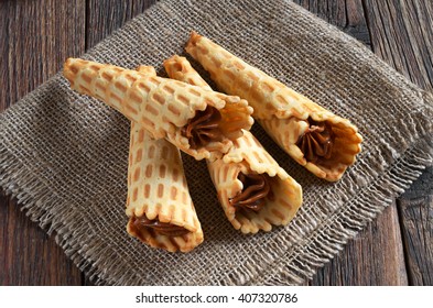 Waffle Cones With Sweet Boiled Condensed Milk On Rustic Wooden Table