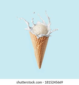 Waffle corn of fresh natural homemade sweet ice-cream with milk splash against light blue background, copy space. Healthy natural dessert. - Powered by Shutterstock