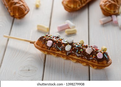 Waffle lollies with marshmallows. Delicious dessert on a rustic wooden table. Popular item of cafe menu.