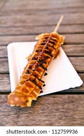 waffle on a stick drizzled lightly with chocolate