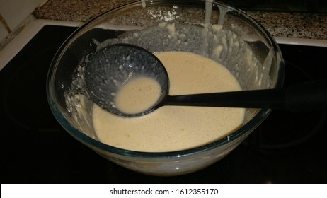 Waffle and Pancake batter in a bowl with ladel