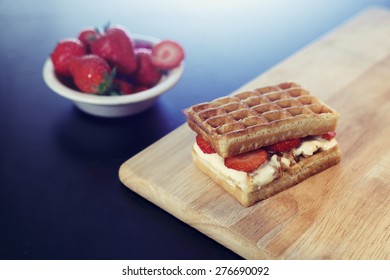 Waffle Sandwich With Caramel Ice Cream Dessert On Wood Cutting Board With Strawberries 