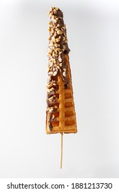 waffle stick, glazed  with chocolate and peanuts, white background