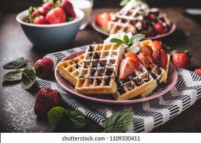 Waffles with berries, strawberries, chocolate on top and mint