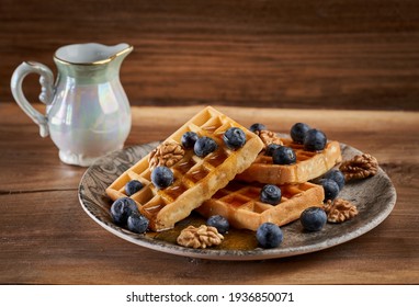 Waffles with blueberries and walnuts glazed in maple syrup