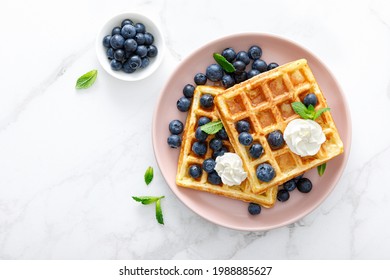 Waffles with cream cheese and fresh blueberries, healthy food, breakfast. Waffles with berries. - Powered by Shutterstock