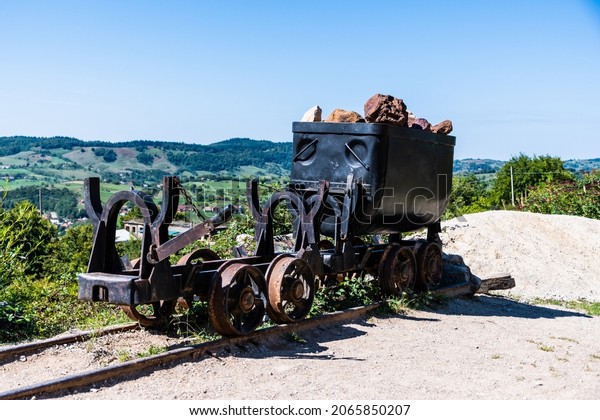 Wagon with bauxite rocks in front\
of the Farcu mine. Apuseni Mountains, Bihor County,\
Romania.