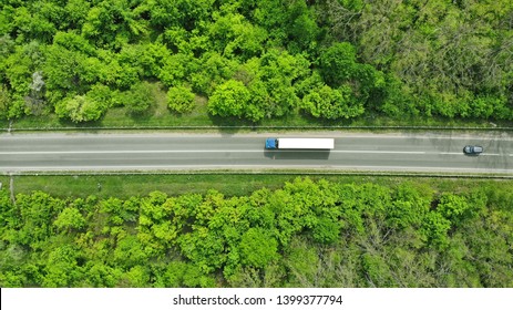 Wagon driving on the highway, aerial. Transport logistics background top view. 