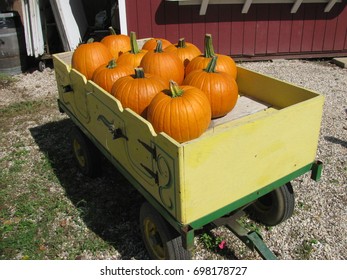 A wagon full of pumpkins.