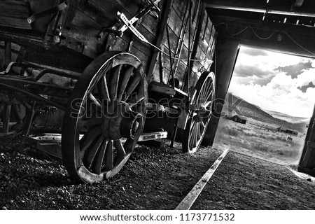 Wagon in an open door barn both from late 1800’s-early 1900’s, found at a ghost town in California