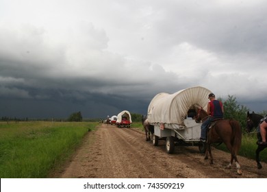 A wagon train and a dark storm in Alberta, Canada 