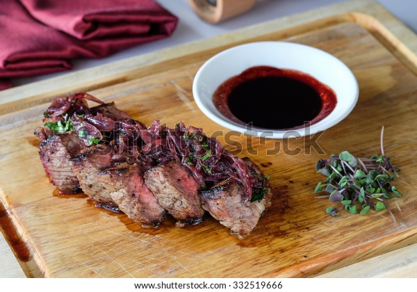 Wagyu rib eye steak with caramelized onions and red\
wine sauce