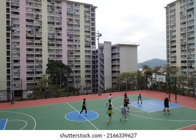 Wah Fu, Hong Kong: 19 December 2021: A Group Of Youngsters Playing Basketball In A Basketball Court In Wah Fu Estate Before Its Redevelopment.