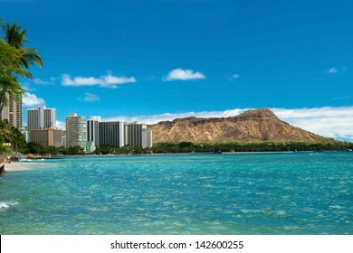 Waikiki beach with azure water in Hawaii with Diamond Head in background.