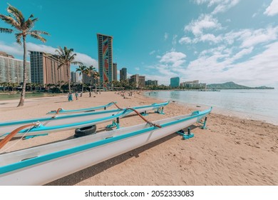 Waikiki beach landscape with racing canoe boats. Honolulu city, Oahu, Hawaii, USA famous summer travel destination.