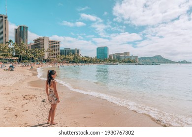 Waikiki beach travel lifestyle. Tourist woman walking in Honolulu, Hawaii during winter holidays. Summer vacation destination.