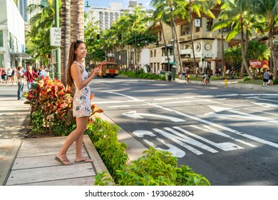 Waikiki Tourist Woman Walking In Honolulu City Street Using Mobile Phone. Hawaii Summer Vacation Destination.