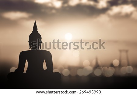 Waisak day concept: Sepia tone, silhouette Budha with blurred tourist attraction in thailand on sunset background