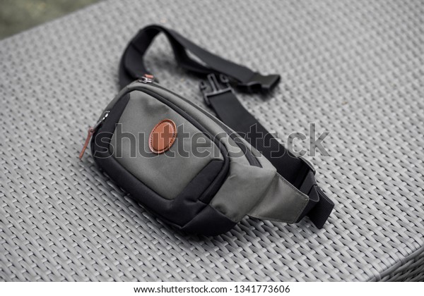 waist bag lies on a gray\
background