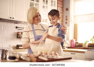 Waist up of boy and grandmother in the kitchen - Shutterstock ID 567349306