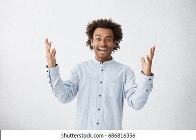 Waist Up Picture Of Emotional Excited Young Employee Exclaiming In Shock And Full Disbelief, Gesturing Actively, Excited After He Got Promotion At Work. Human Emotions, Feelings, Reaction And Attitude