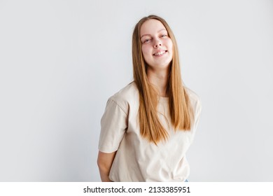 Waist Up Portrait Of Beautiful European 17 Y.o. Woman Posing Isolated Against Grey Studio Wall Background With Copy Space For Your Text, Smiling Teen Girl 