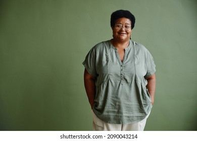 Waist Up Portrait Of Black Senior Woman Smiling At Camera While Standing Against Green Background, Copy Space