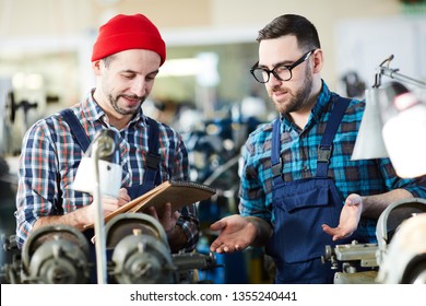 Waist Up Portrait Of Factory Worker Training New Employee During Onboarding Process