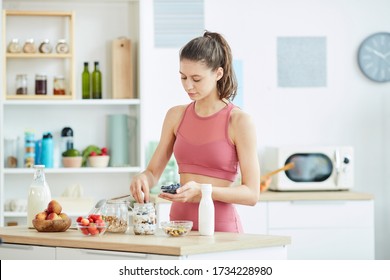 Waist Up Portrait Of Fit Young Woman Making Healthy Granola Snack In Kitchen Interior, Copy Space