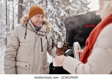 Waist Up Portrait Of Happy Mature Couple Enjoying Cup Of Hot Coco Outdoors During Winter Hike