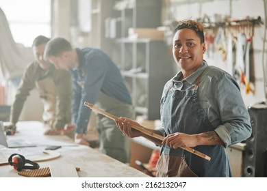 Waist Up Portrait Of Latin American Female Artisan Looking At Camera In Hazy Workshop, Copy Space