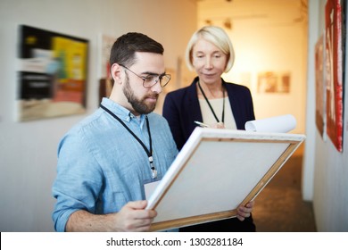 Waist up portrait of modern bearded man buying picture in art gallery or museum, copy space - Shutterstock ID 1303281184
