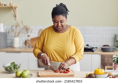 Waist Up Portrait Of Smiling Black Woman Cooking Healthy Meal In Kitchen And Cutting Vegetables, Copy Space