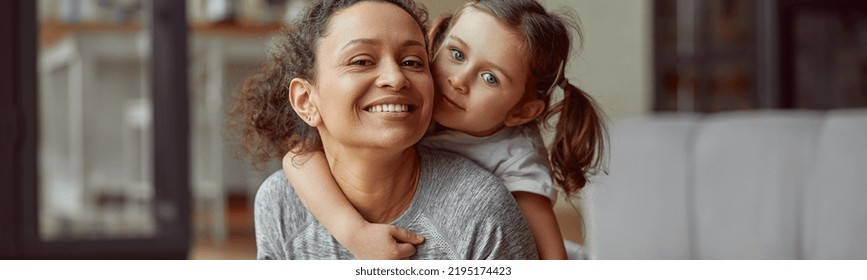 Waist Up Portrait Of Smiling Girl Hugging Her Mom While They Are Doing Training At Home