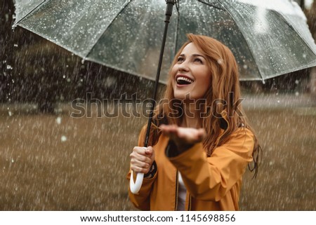 Similar – Image, Stock Photo Content woman under umbrella on beach in summer looking at camera