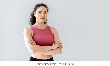 Waist up portrait of sporty fit woman in top with crossed arms isolated on white background. Healthy lifestyle concept. Confident smiling fitness trainer posing and looking at camera. Copy space - Powered by Shutterstock