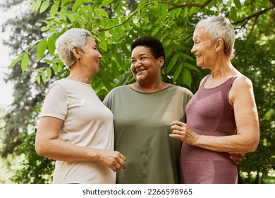 Waist up portrait of three active senior women smiling joyfully outdoors - Powered by Shutterstock