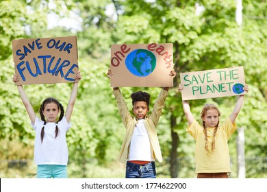 Waist Up Portrait Of Three Children Holding Signs With SAVE PLANET SAVE FUTURE While Protesting For Nature Outdoors, Copy Space